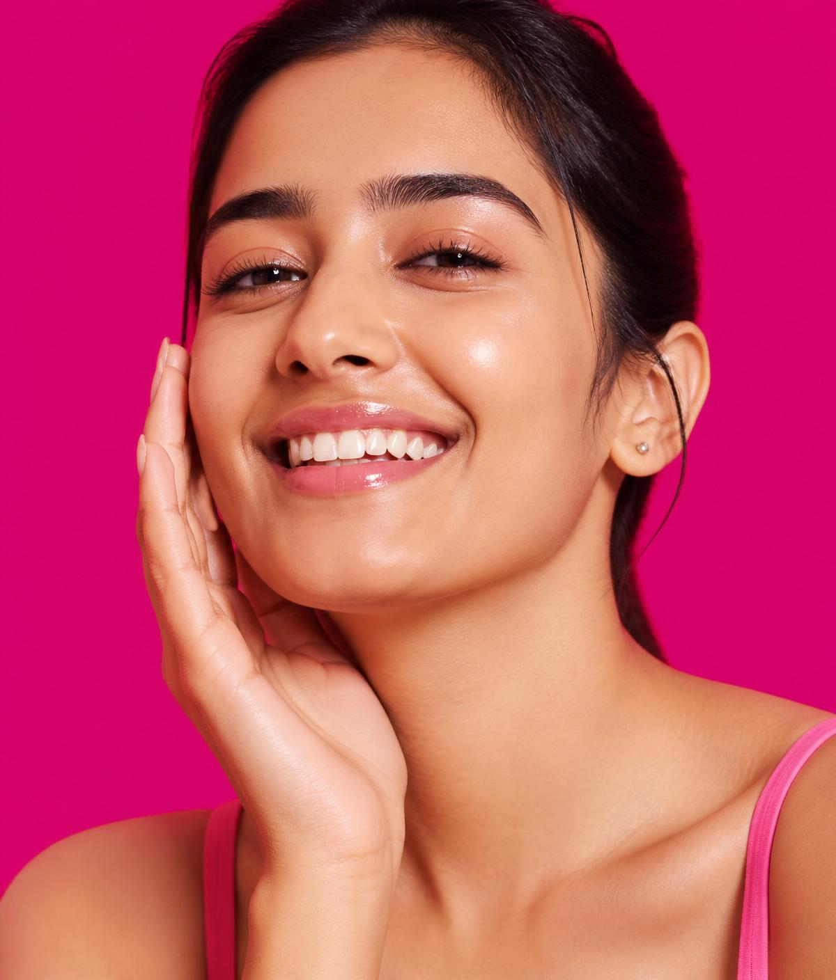 Smiling Indian woman with clear, radiant skin after using the Lumara vitamin C serum, hydrating moisturiser and SPF 50 sunscreen routine